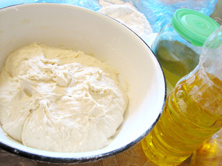 yeast dough in tureen, preparing buns at home