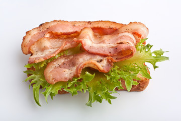 hot sandwich with fried bacon and lettuce