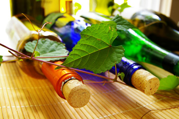 various wine bottles and corks with grape vines
