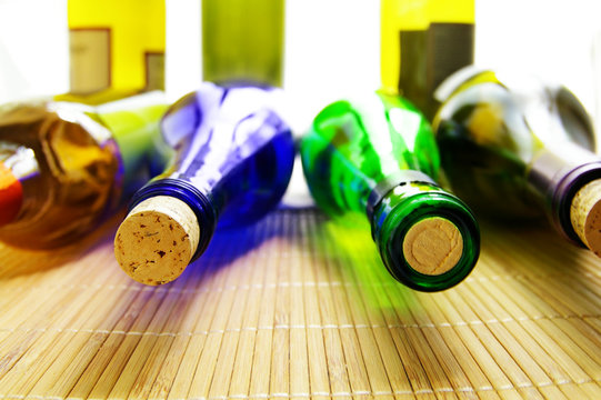 closeup of various wine bottles and corks