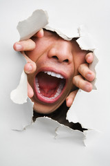Male mouth screaming from cracked wall
