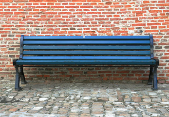 Bench against a brick wall