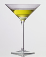 yellow drink in cocktail glass
