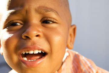 A Handsome little African American Boy smiling for the camera