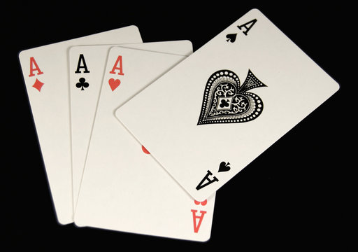 four aces on black cloth table top