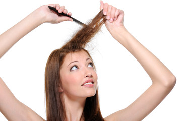 backcombing long brunette female hair