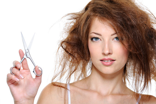 Female with backcombing hair and with scissors
