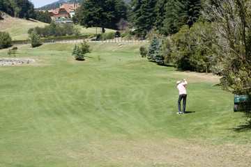 Aa man playing golf