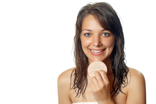 young beautiful woman cleaning face with sponge.
