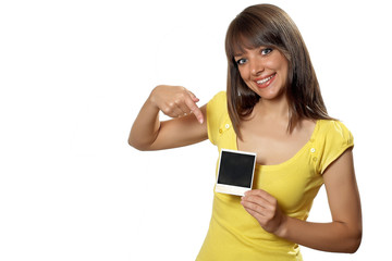 Woman holding an old polaroid film blank