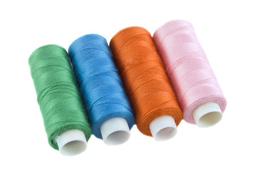 Many colorful threads over the white background