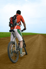 Fototapeta na wymiar mountain bike race on ground road in the field.