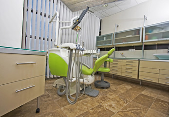 Modern dentist's chair in a medical room. - obrazy, fototapety, plakaty