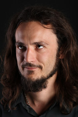 Portrait of guy with long hair and goatee looking up