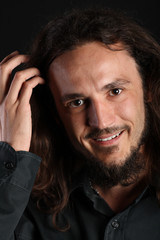 Handsome guy with toothy smile and hand in hair