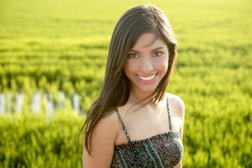 Beautiful brunette indian woman in green rice fields