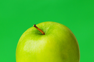 Green apple against green background
