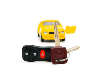 Car keys and car at background isolated on white