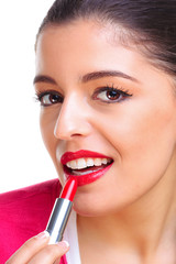 Woman applying red lipstick