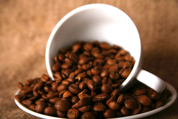 cup, dish and beans of coffee