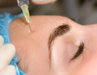 Cosmetic injection in woman's face