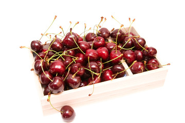 red cherries in a box isolated on white