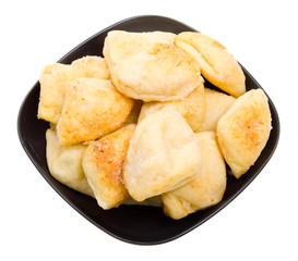 Close-up russian bread loaf stacked on a black plate on white
