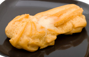 fresh cake on black plate. Isolated on white background