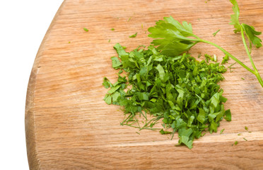Close-up cutting board with green chopped herbs