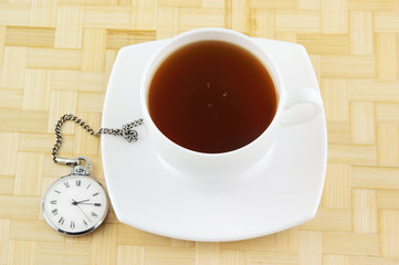 Cup of tea and old watch
