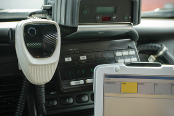Police car radio and computer inside car.