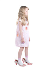 Little girl playing with big mom shoes