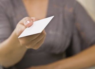 Woman Holding out Business Card