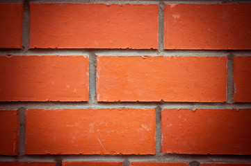 Obraz premium brick wall made of red / orange bricks.