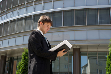 Man in suit near modern building