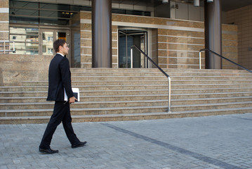 Man in suit near modern building