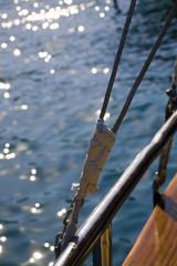 rigging of sail ship and sea waves with the sun specks