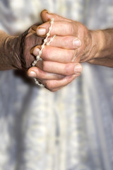 hands of old woman by prayer