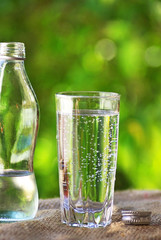 Glass and bottle of cold water.