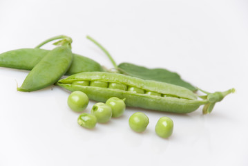 freshly picked green garden peas with stalk and leaves