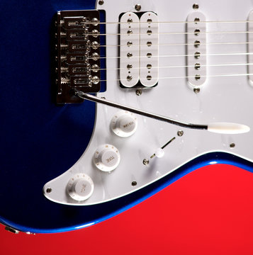 Blue Guitar Isolated On Red