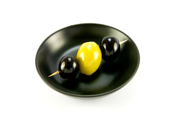 Three Olives in a Small Black Bowl