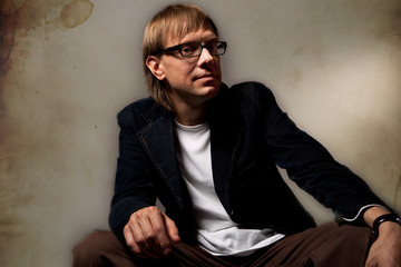 pretty young man in jacket over grunge background