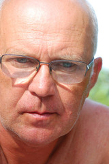 handsome senior man wearing glasses in metal frame