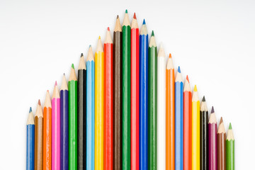 Assortment of coloured pencils with shadow on white background