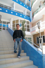 Young man standing on the stairs.