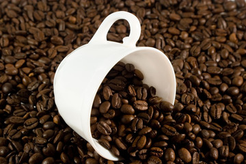 Cup with coffee beans (with coffee beans as a background)