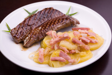 Bavarian steak with potatoes isolated on dark background