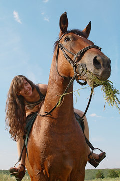Girl sits on horseback