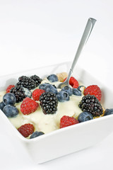 A bowl of cereal with fresh berries